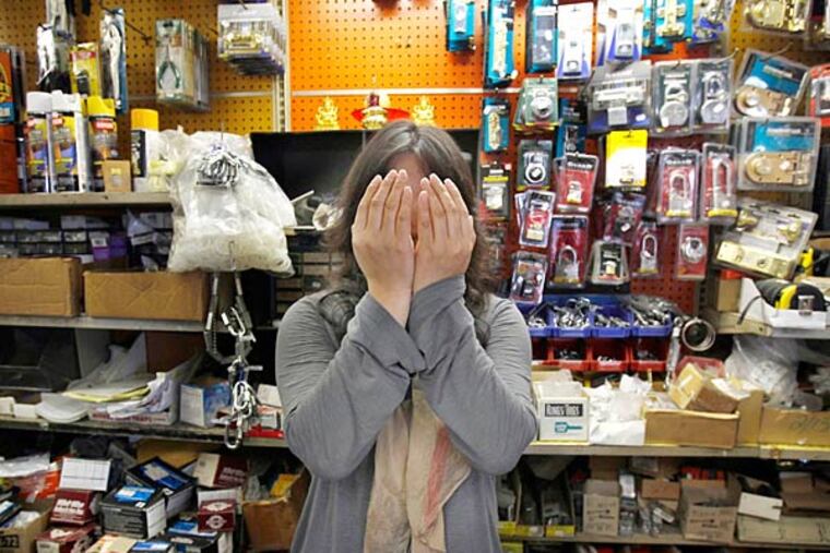 Yun "Karen" Jiang, who didn't want to show her face, is seen in her hardware shop in Philadelphia on October 8, 2013. (DAVID MAIALETTI / Staff Photographer)