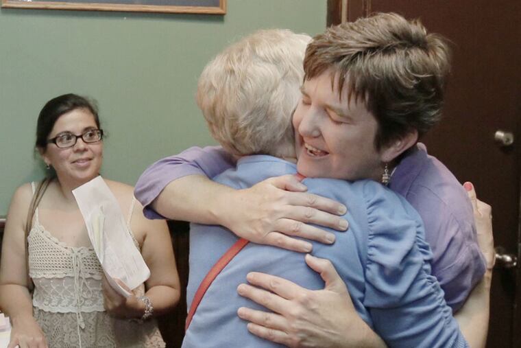 Margie Winters (right) after a meeting of parents upset by her firing for being in a same-sex marriage. ELIZABETH ROBERTSON / Staff Photographer