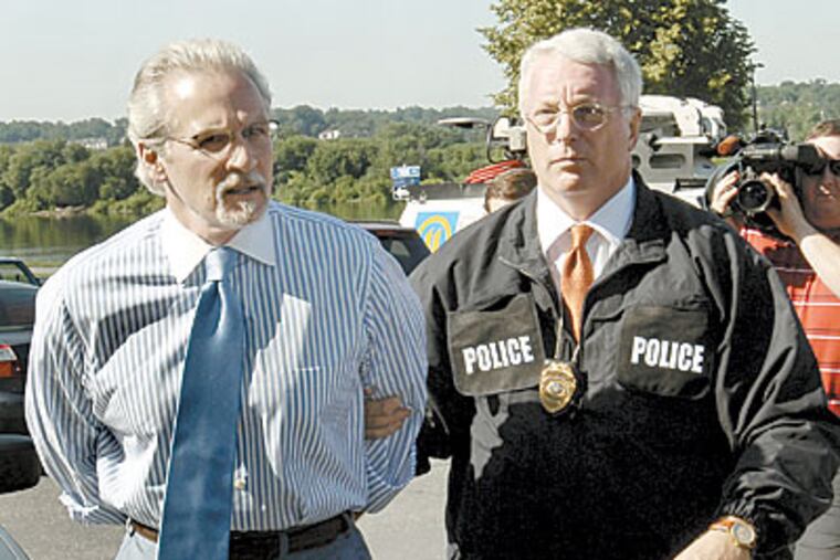 Former Pennsylvania Democratic House Whip Mike Veon, left, arrives in hand cuffs for his arraignment on Friday. Veon and 11 others are accused of a criminal scheme to have Pennsylvania taxpayers underwrite political campaigns. (AP Photo/Bradley C Bower)