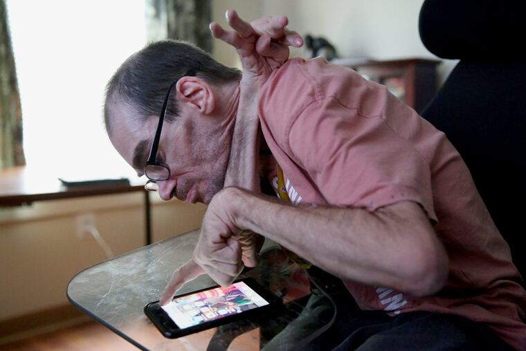 In a photo taken last year, Richard Bernard, who has dystonia, a disorder causing involuntary muscle contractions, demonstrated how he could operate his apartment’s thermostat, lights and door access from his phone at Inglis Gardens.