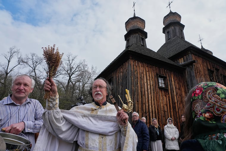 Priests bless believers and their Easter baskets to mark Orthodox Easter, in Pyrohiv, close to Kyiv, Ukraine, Sunday, April 12, 2026.