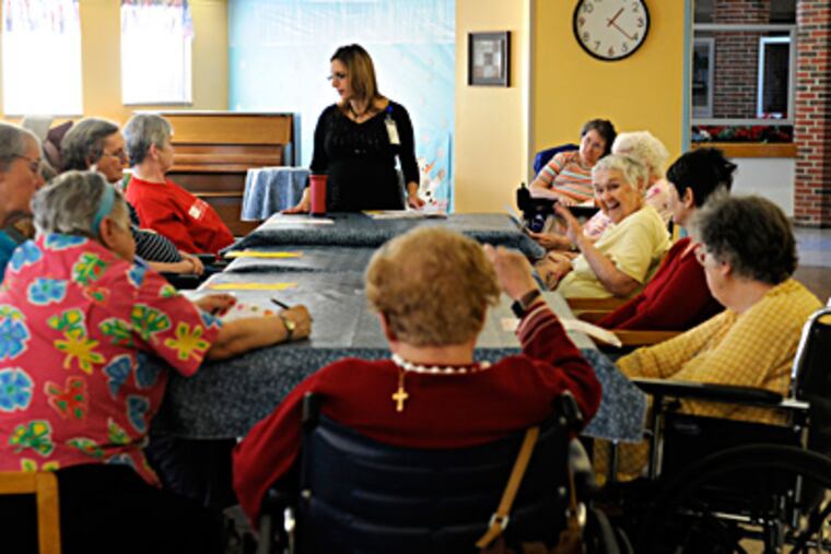 Buttonwood administrator Eve Cullinan with the residents' council. (Tom Gralish / Staff Photographer)