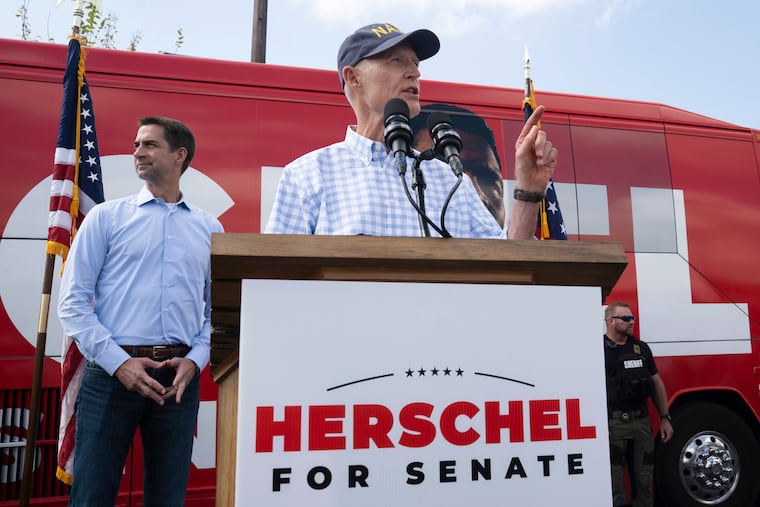 Sen. Tom Cotton (R., Ark.) (left) listened as Sen. Rick Scott (R., Fla.) spoke during a campaign stop for Georgia Republican Senate candidate Herschel Walker in Carrollton, Ga., last month. Scott, chairman of the National Republican Senatorial Committee, rolled out an 11-point plan to “rescue America” that calls for sunsetting all federal programs every five years, including Social Security and Medicare.