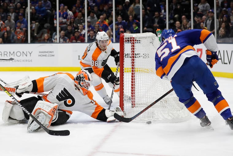 Brian Elliott (left) stops a shot by the Islanders' Valtteri Filppula during the second period.