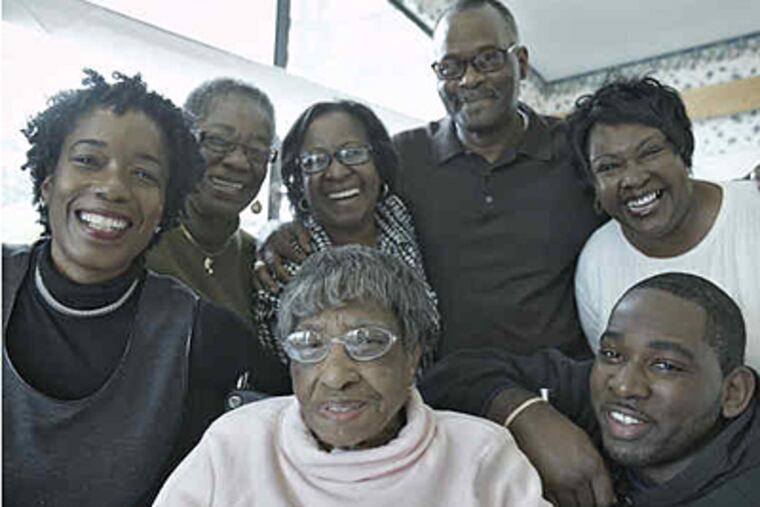 Sarah Carter Perry Brown (center) is surrounded by family. A new book by Brown's great-niece Caryl Lucas (far left) documents her "long and spirit-filled life." (David M Warren / Staff)