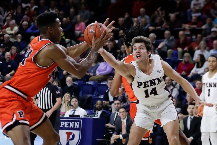 Penn forward Max Martz reaches for the ball against Princeton center Richmond Aririguzoh during the first half.