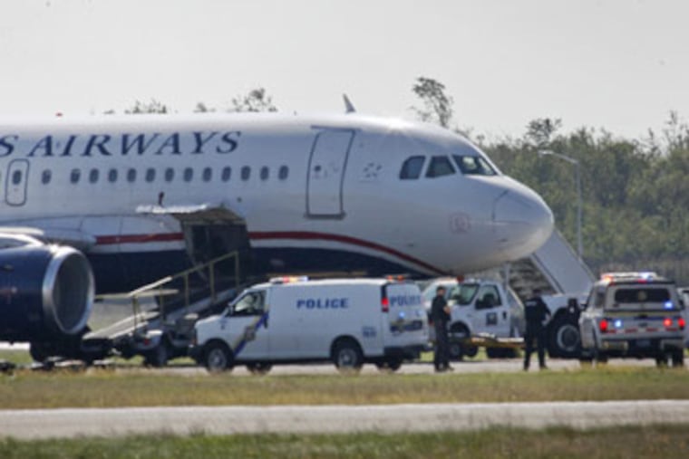 Philadelphia police investigate suspicious activity on a USAirways plane at Philadelphia international airport on Thursday, October 7, 2010. (Alejandro A. Alvarez / Staff Writer)