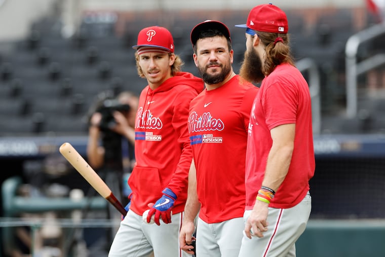 Kyle Schwarber (center) walks with teammates Brandon Marsh and Bryson Stott after batting practice on Friday at Truist Park in Atlanta. The Phillies will take on the Braves in Game 1 of the NLDS on Saturday.