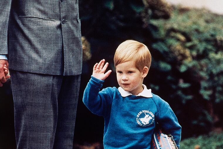 In this Sept. 16, 1987 file photo, Britain's Prince Harry waves to photographers on his first day at a kindergarten in Notting Hill, West London. Princess Diana’s little boy, the devil-may-care prince with the charming smile, has become a father. But preschool can raise issues even for the wealthy and powerful. (AP Photo/Martin Cleaver, File)