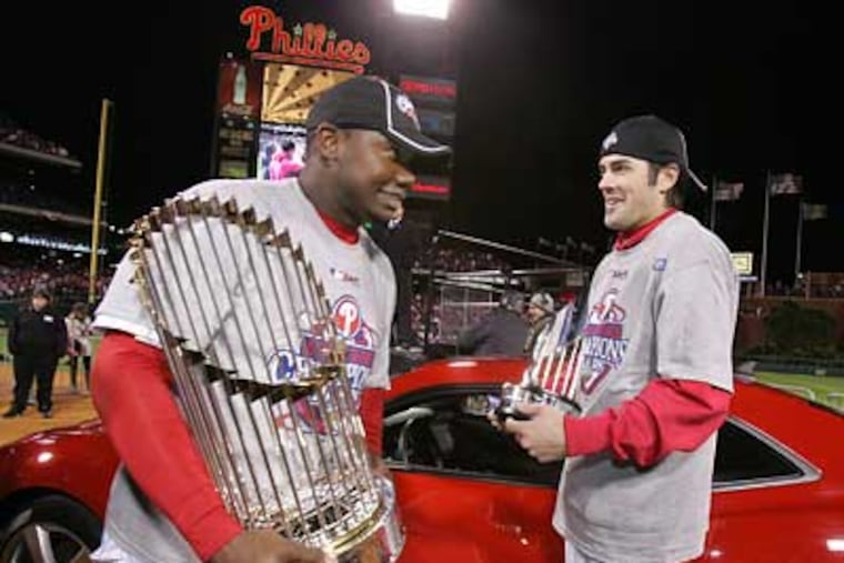 Ryan Howard holds the World Series trophy and Cole Hamels holds the MVP trophy after the Phillies won game 5 of the World Series. (Barbara L. Johnston / Staff Photographer)