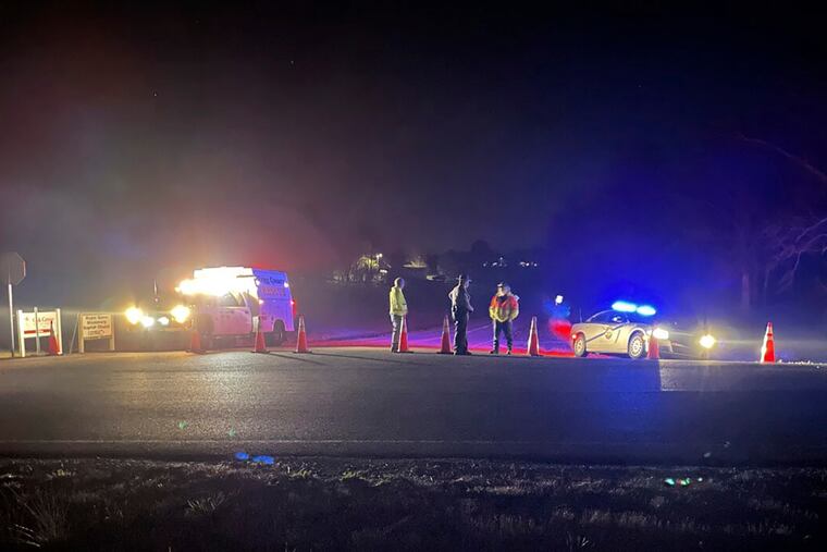Emergency responders are seen near a site where two military helicopters crashed Wednesday night in southwestern Kentucky.