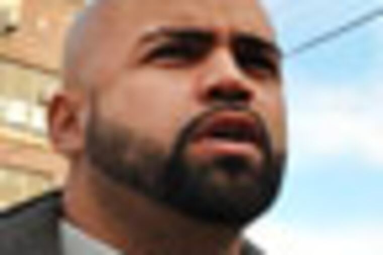 Brothers Edwin Desamour (left), president & founder of Men in Motion in the Community and his brother Eric Desamour, a former drug dealer, walk along Allegheny Avenue. ( Sharon Gekoski-KImmel / Staff Photographer ) Nov. 10, 2010. Editors Note: PHUNGER12 21/23