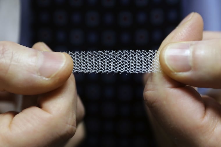 Jeffrey Clemons, a pelvic reconstructive surgeon in Tacoma, Wash., holds a sample of transvaginal mesh used to treat incontinence in women. Clemons and more than 60 other state surgeons sent a letter to state Attorney General Bob Ferguson, arguing that his consumer-protection lawsuit against Johnson & Johnson over the mesh products might scare patients away from the best treatment options.