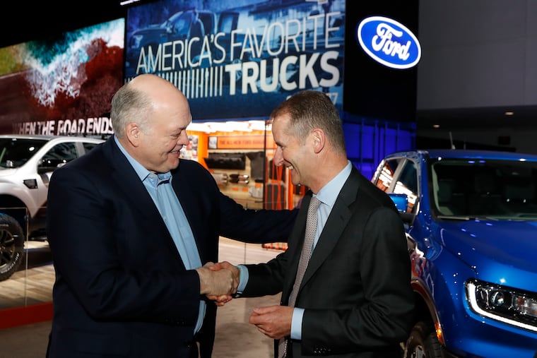 Ford Motor Co. president and CEO Jim Hackett (left) meets with Herbert Diess, CEO of Volkswagen AG, Monday, Jan. 14, 2019, at the North American International Auto Show in Detroit.
