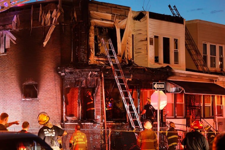 Firefighters look for hotspots after fighting a fire at 2046 Bonaffon St. in Phila., Pa. on March 27, 2020.