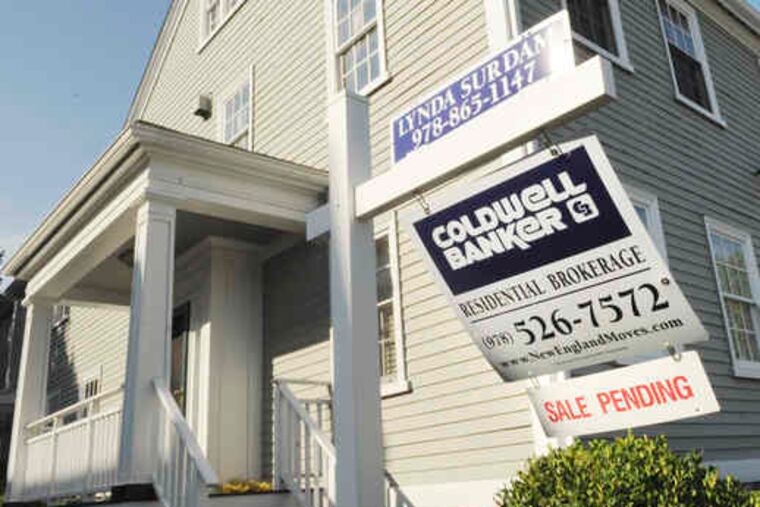 A sign shows a sale pending on a Massachusetts home. Resales in July posted the largest monthly gain in at least 10 years as first-time buyers took advantage of a federal tax credit.