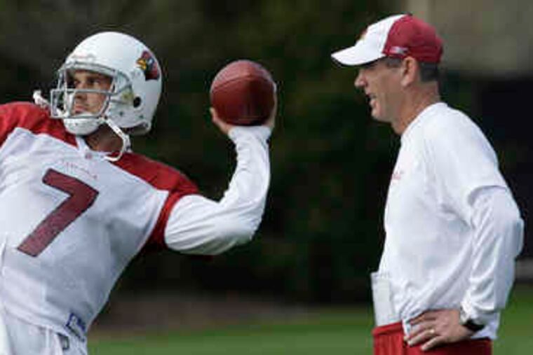 Former Heisman Trophy winner Matt Leinart throws during practice as quarterbacks coach Jeff Rutledge looks on in Tampa, Fla.