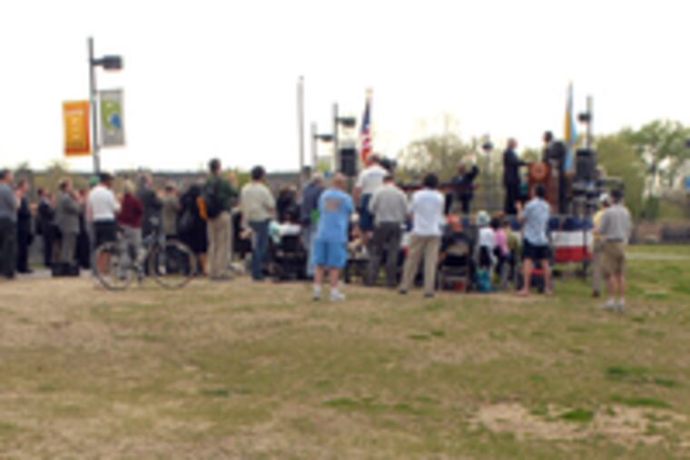 Kevin Gallagher of Manayunk, a regular user of the park's trail, watches as the mayor and other officials sign off on documents making the park's increased accessibility official.