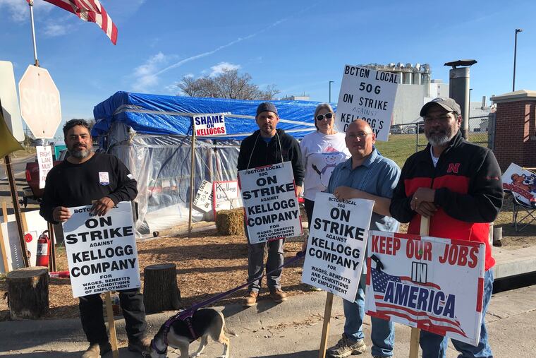 Striking Kellogg's workers stand outside the Omaha, Neb., cereal plant on Dec. 2, 2021.