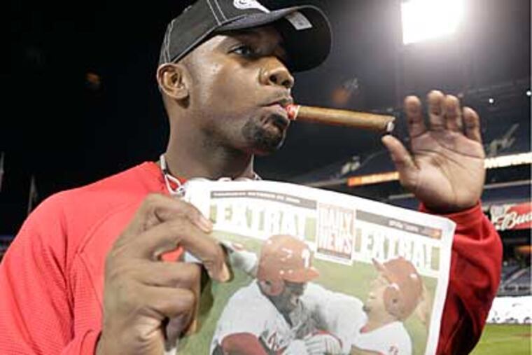 Phillies' Ryan Howard celebrates his return to the World Series with a cigar and a copy of the Daily News. (Yong Kim / Staff Photographer)