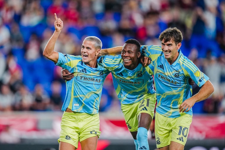 Cavan Sullivan (left) celebrates with Danley Jean Jacques (center) and Milan Iloski after scoring his goal in the Union's win at Red Bull New York on Saturday.
