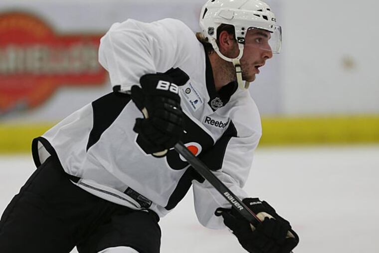 Shayne Gostisbehere passes the puck during a Flyers developmental camp. (David Maialetti/Staff Photographer)