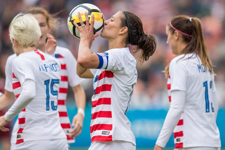 Carli Lloyd kisses the game ball after scoring her 100th goal for the United States women’s national soccer team in a 6-2 win over Mexico.
