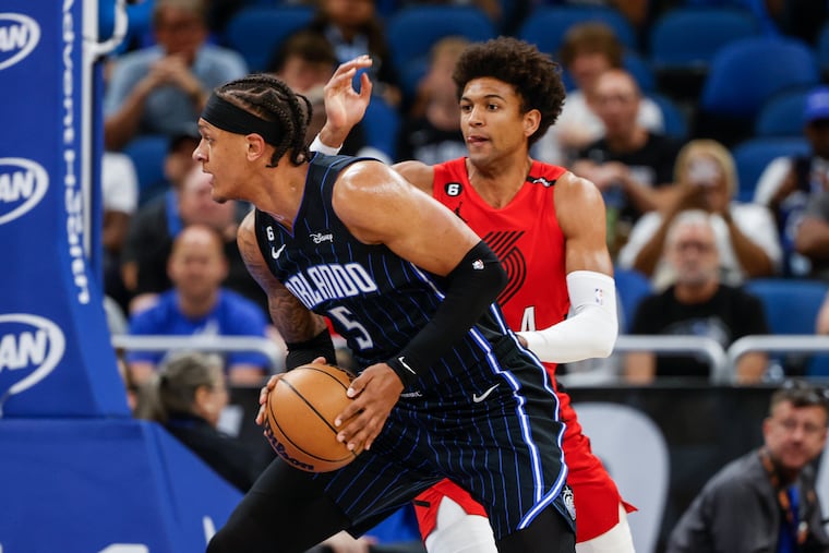 Orlando Magic forward Paolo Banchero (5) makes a move around Portland Trail Blazers forward Matisse Thybulle.