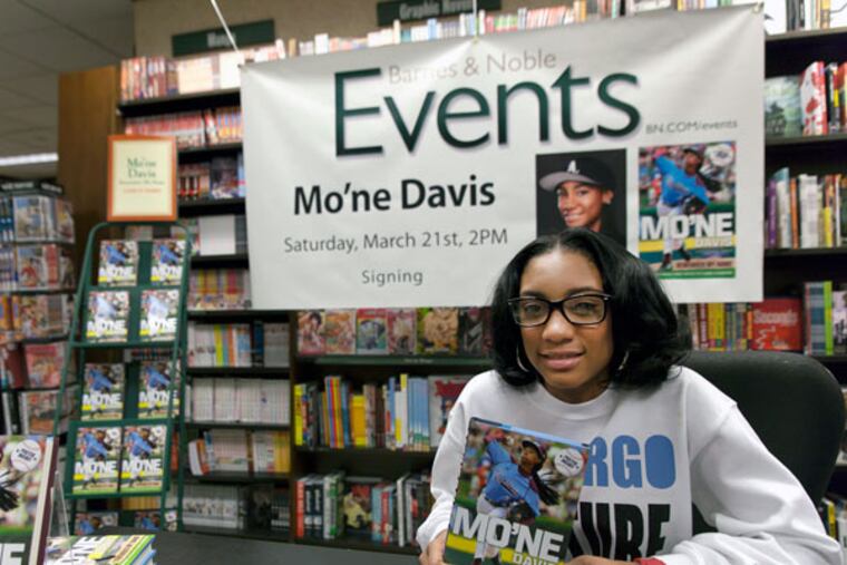 Mo'ne Davis signs copies of "Mo'ne Davis: Remember My Name" at the Barnes & Noble bookstore at 18th and Walnut Streets. (Chanda Jones / Staff Photographer)