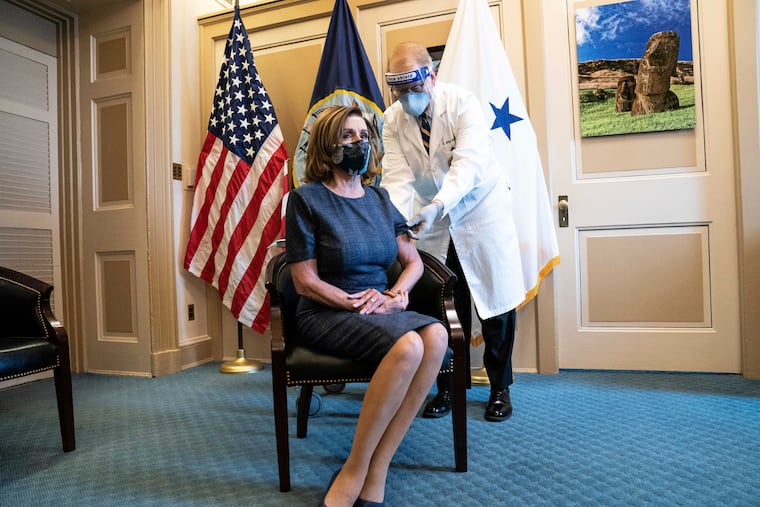 Speaker of the House Nancy Pelosi, D-Calif., sits and waits before being inoculated with a Pfizer-BioNTech COVID-19 vaccine shot by Dr. Brian Monahan.