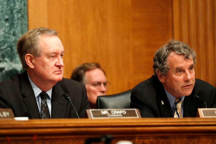 Senate Banking Committee Chairman Mike Crapo (R., Idaho) (left) and the committee's ranking Democrat, Sherrod Brown of Ohio, listen as Federal Reserve Chairwoman Janet Yellen testifies.