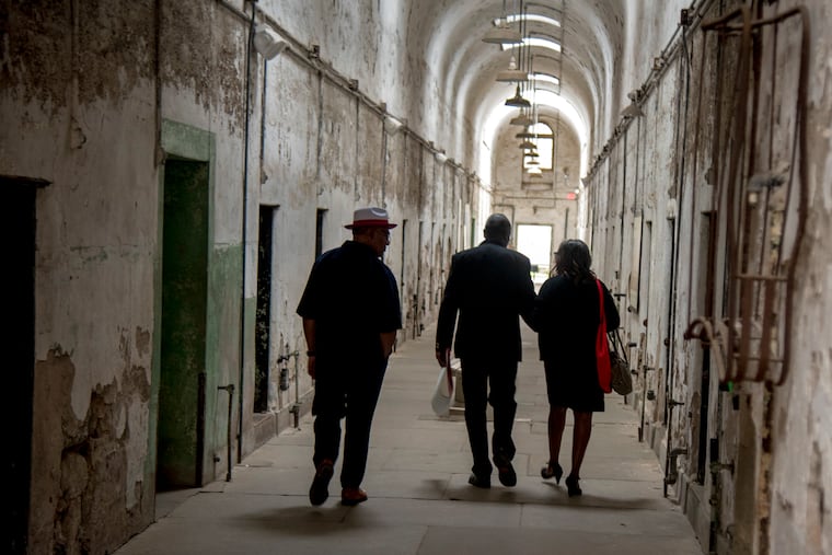 The last death row inmate at Eastern State Penitentiary, Samuel Barlow, and his fiancée, Karen Lee, tour an old cellblock as he returns to his old prison for the first time to receive an award from the Prison Society on Wednesday.