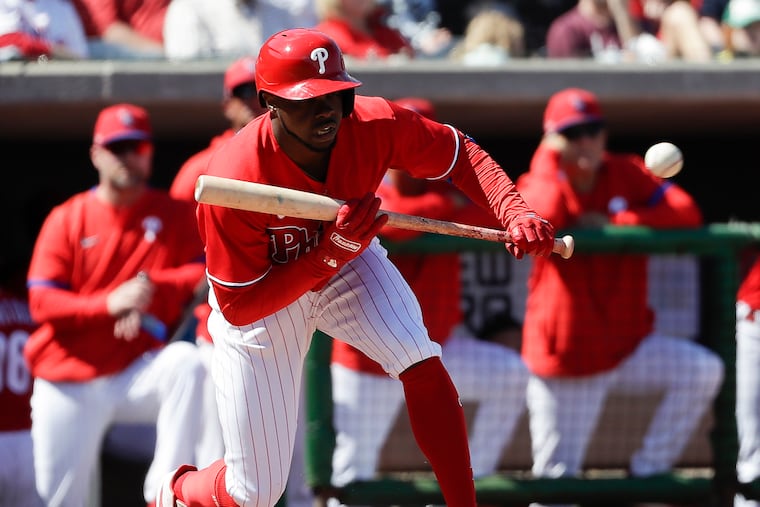 Phillies outfielder Roman Quinn prepares to bunt the baseball against the Baltimore Orioles in a spring training game at Spectrum Field in Clearwater, Fla.
