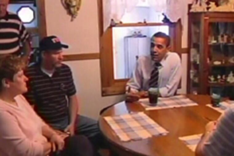 Democrat Barack Obama talks with a family in an image from his 30-minute campaign ad that ran on television last night.The commercial blended prerecorded views of Obama speaking in different settings with scenes of Americans discussing economic and health-care troubles, and testimonials to Obama by politicians, business executives and others.