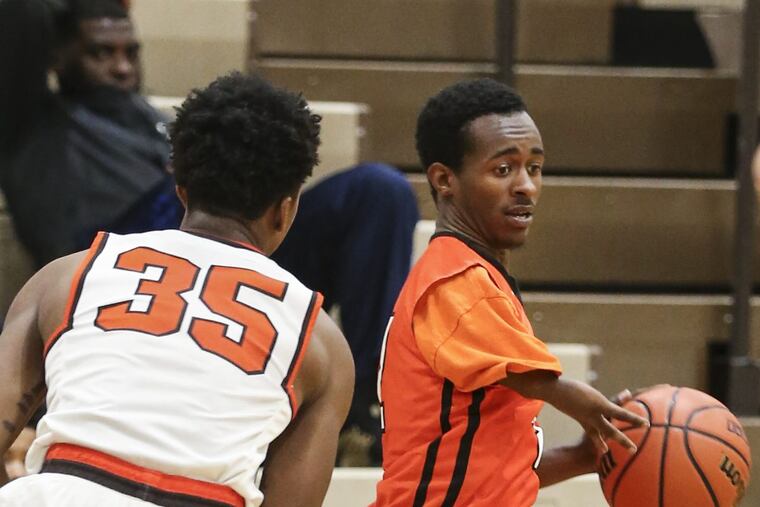 Woodrow Wilson senior Trae Walker drives on Cherokee’s Tymere Bennett.