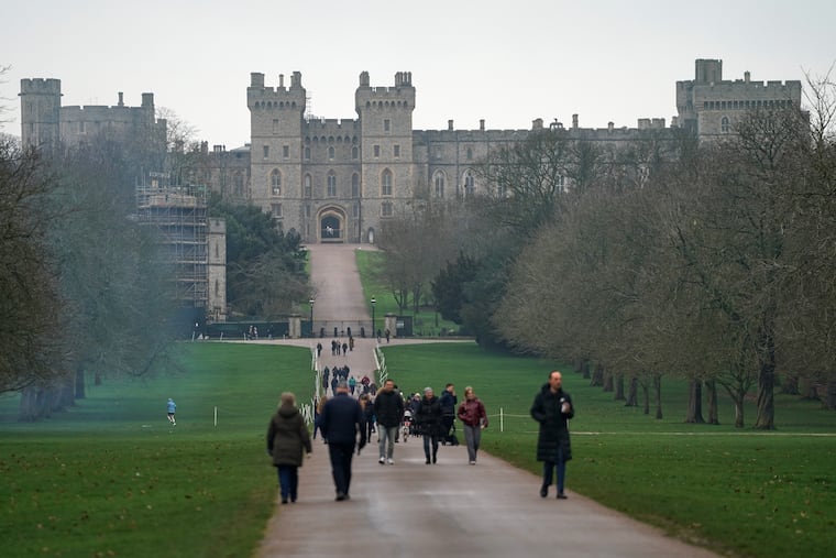 Visitors walk around Windsor Castle on Thursday after Andrew Mountbatten-Windsor was arrested by British police on suspicion of misconduct in public office.