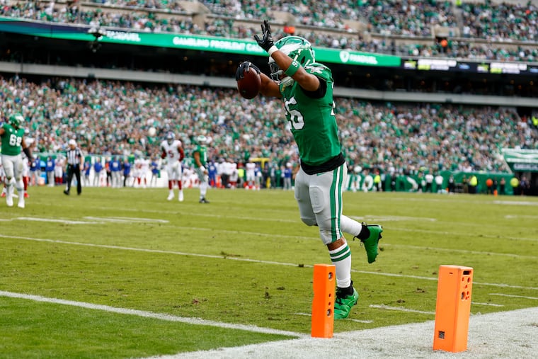 Eagles running back Saquon Barkley leaps into the end zone after catching a touchdown pass in the second quarter.