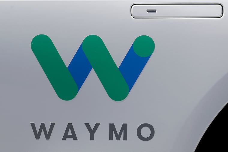 FILE - In this May 8, 2018, file photo, a Waymo logo is displayed on the door of a car at the Google I/O conference in Mountain View, Calif. Google's self-driving car spinoff Waymo is teaming up with Lyft in Arizona to attempt to lure passengers away from ride-hailing market leader Uber.