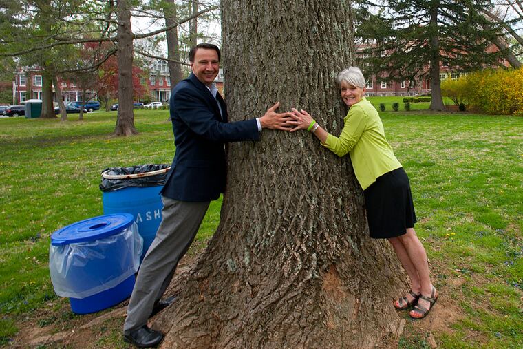 U.S. Rep. Ryan Costello and West Chester Mayor Carolyn Comitta hug a tree in Barclay Park in honor of Earth Day and the ribbon-cutting for the newly opened park in West Chester.