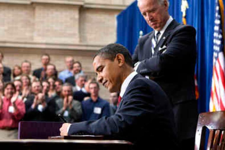 President Obama signs the $787 billion stimulus plan in Denver as Vice President Biden watches. Obama said the plan marked "the beginning of what we need to do to create jobs for Americans."