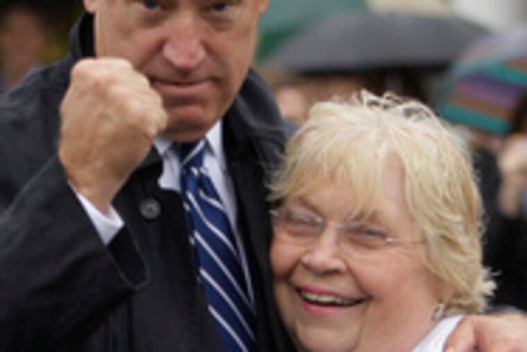 Biden, doing a Rocky pose, stands with Delaware state Sen. Nancy Cook at the traditional parade.