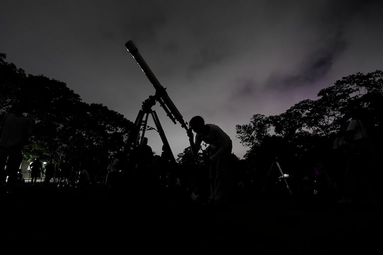 A girl looks at the moon through a telescope in Caracas, Venezuela, in 2022.