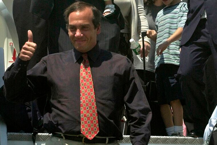 FILE - In this Tuesday, July 9, 2002, file photo, Rabbi Yechiel Eckstein gestures as he walks outside an El-Al plane that brought about 400 North American Jews to Ben Gurion airport near Tel Aviv, Israel. Eckstein, an Israeli American rabbi who raised hundreds of millions of dollars for Israel by promoting closer ties with evangelical Christians around the world, died Wednesday, Feb. 6, 2019.