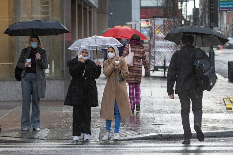 Umbrellas come out Tuesday morning Feb. 22, 2022, in Center City Philadelphia. Picture was taken on Market Street at 16th Street.