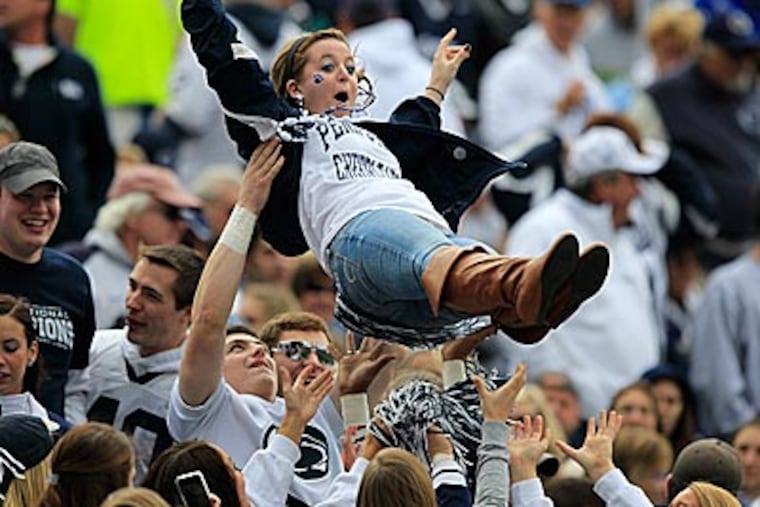 A student is tossed in the air as fans celebrate a Penn State touchdown. (Gene J. Puskar/AP)