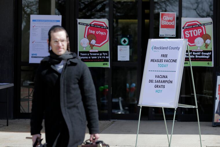 FILE - In this March 27, 2019 file photo, signs about measles and the measles vaccine are displayed at the Rockland County Health Department in Pomona, N.Y. Measles continues to spread in the United States, with more 704 cases reported so far this year spread among 22 states.