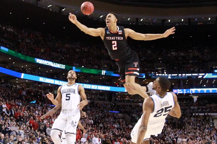 Zhaire Smith cannot finish the dunk over Mikal Bridges during the 2017-18 college season.