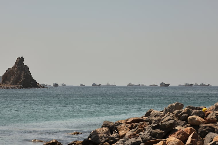 Tankers and cargo vessels are seen in the Gulf of Oman, along shipping routes linking the Strait of Hormuz and the Arabian Sea, Tuesday, June 16, 2026. Iran is taking steps to establish insurance requirements for the strait.