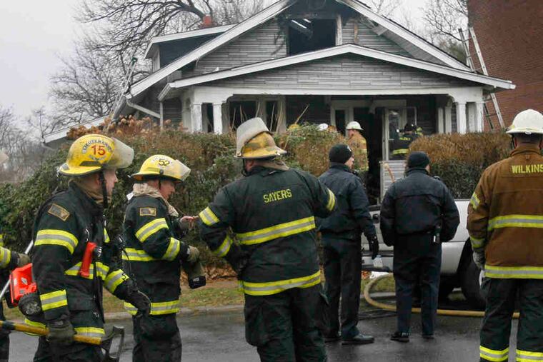 Philadelphia firefighters outside Robert Irvine's house on the 4100 block of East Howell Street. Irvine worked for the city as a welder. Neighbors said he was a Vietnam veteran who lived alone.
