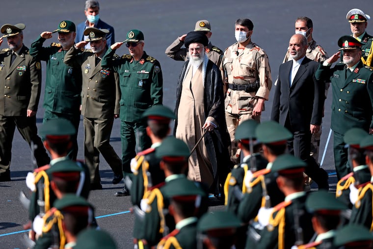 In this picture released by the official website of the office of the Iranian supreme leader, Supreme Leader Ayatollah Ali Khamenei, center, reviews a group of armed forces cadets during their graduation ceremony accompanied by commanders of the armed forces, at the police academy in Tehran, Iran, Monday, Oct. 3, 2022. Khamenei responded publicly on Monday to the biggest protests in Iran in years, breaking weeks of silence to condemn what he called “rioting” and accuse the U.S. and Israel of planning the protests.